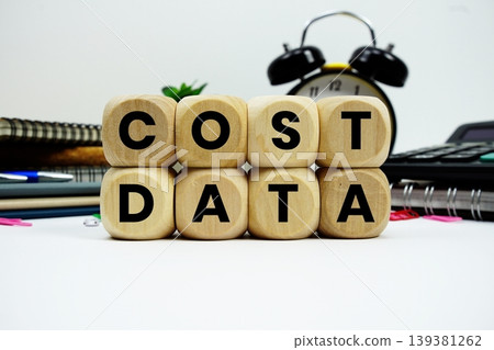 Cost Data alphabet letters with calculator and alarm clock on white background Cost Data alphabet letters with calculator and alarm clock on white background 139381262