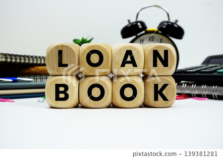 Loan Book alphabet letters with calculator and alarm clock on white background Loan Book alphabet letters with calculator and alarm clock on white background 139381281