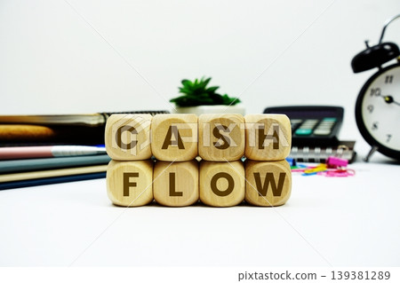 Cash Flow alphabet letters with calculator and alarm clock on white background Cash Flow alphabet letters with calculator and alarm clock on white background 139381289