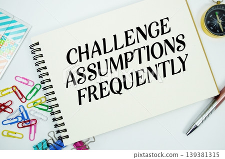 Challenge Assumptions Frequently text message written on notepad with stationery flat lay on white background Challenge Assumptions Frequently text message written on notepad with stationery flat lay on white background 139381315