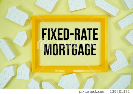 Fixed-Rate Mortgage text with house models on yellow background Fixed-Rate Mortgage text with house models on yellow background 139381321