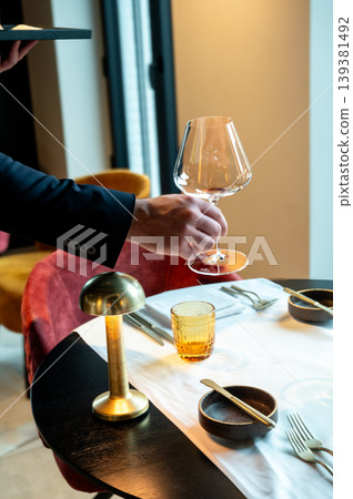 Elegant dining setting scene. Sophisticated dining environment with stylish decor and warm lighting 139381492