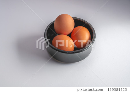 Organic Brown Eggs in Dark Bowl Organic Brown Eggs in Dark Bowl 139381523
