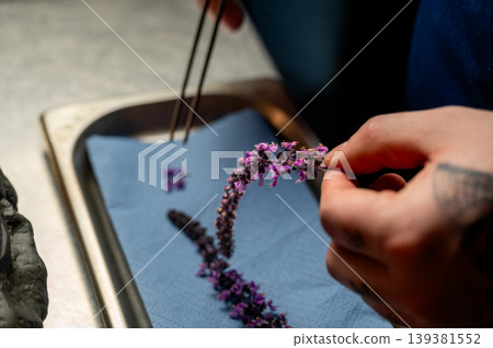 Precise arrangement of fragrant lavender petals on gourmet dessert for visual appeal Precise arrangement of fragrant lavender petals on gourmet dessert for visual appeal 139381552