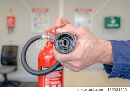 Image of a fire drill with a fire extinguisher in place. Image of a fire drill with a fire extinguisher in place. 139381623