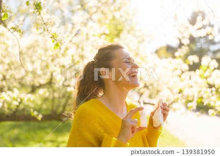 Happy Woman Managing Spring Allergies with Relief Spray 139381950
