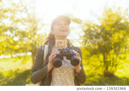 Excited Woman Exploring Wildlife in Golden Hour Light Excited Woman Exploring Wildlife in Golden Hour Light 139381966