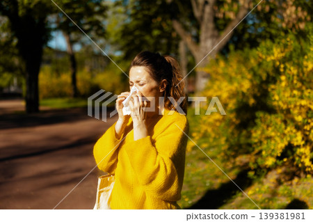 Woman Sneezing in Spring Park with Seasonal Allergies 139381981