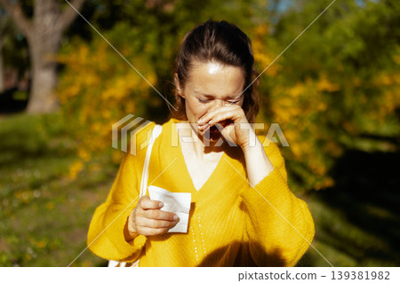 Woman with Allergic Rhinitis Discomfort in Sunny Garden Woman with Allergic Rhinitis Discomfort in Sunny Garden 139381982