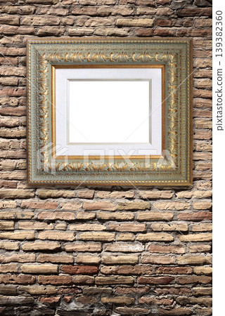 Vertical banner with blank picture frame with passe-partout, hanging on brick wall. Empty Vintage gold-leafed wooden frame with decorative carvings on a loft-style brick wall. Copy space for text Vertical banner with blank picture frame with passe-partout, hanging on brick wall. Empty Vintage gold-leafed wooden frame with decorative carvings on a loft-style brick wall. Copy space for text 139382360