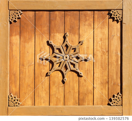 Vintage wooden shutter with rustical naive handmade decor. Retro wood door with simple hand-carved decor. Timber shutters with folk-style carvings. Rustic artisan ornaments. Simple handmade motifs Vintage wooden shutter with rustical naive handmade decor. Retro wood door with simple hand-carved decor. Timber shutters with folk-style carvings. Rustic artisan ornaments. Simple handmade motifs 139382576