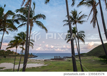 Serene easter island chile coast reveals ancient moai statue under palm tree Serene easter island chile coast reveals ancient moai statue under palm tree 139383574