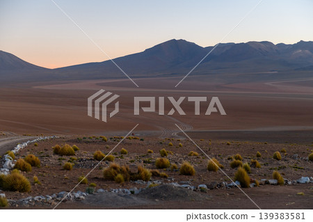 Serene desert mountain landscape at sunset with vast arid land Serene desert mountain landscape at sunset with vast arid land 139383581