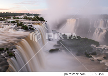 Dramatic iguazu falls reveal majestic rushing river waterfall nature landscape and heavy mist Dramatic iguazu falls reveal majestic rushing river waterfall nature landscape and heavy mist 139383589