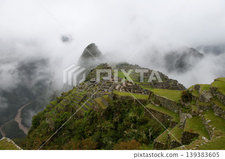 Dramatic machu picchu ancient ruin on mountain covered in mysterious fog Dramatic machu picchu ancient ruin on mountain covered in mysterious fog 139383605