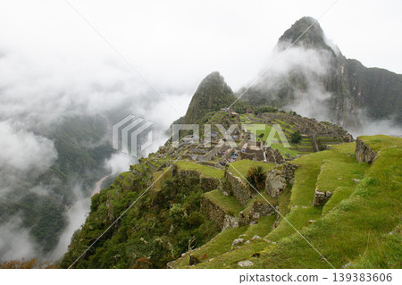 Majestic machu picchu inca ruin on green mountain covered by peaceful cloud Majestic machu picchu inca ruin on green mountain covered by peaceful cloud 139383606