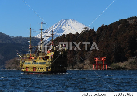 Snow-covered Mount Fuji and a sightseeing boat as seen from Lake Ashi Snow-covered Mount Fuji and a sightseeing boat as seen from Lake Ashi 139383695