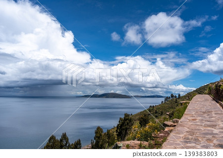 Stone path overlooking nature and terraces on Taquile Island, Lake Titicaca Stone path overlooking nature and terraces on Taquile Island, Lake Titicaca 139383803