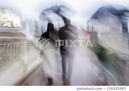 People walking on the sidewalk on a rainy day People walking on the sidewalk on a rainy day 139383983
