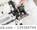 Close-up view of a printer interior showing ink and toner residue, gears, pads and plastic components, useful for repair, maintenance, troubleshooting and technical documentation of office equipment. 139384744