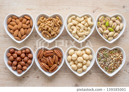 Types of nuts arranged in a heart-shaped dish Types of nuts arranged in a heart-shaped dish 139385001
