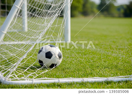 A soccer ball that went into the goal net A soccer ball that went into the goal net 139385006
