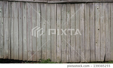 Old rustic fence with gate, background texture of gray rural fence, gray shabby plank fence as empty textured surface with old wood pattern Old rustic fence with gate, background texture of gray rural fence, gray shabby plank fence as empty textured surface with old wood pattern 139385255