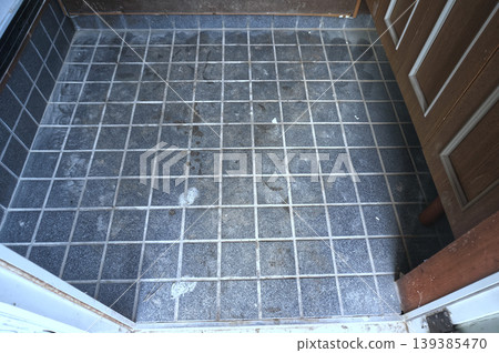 Dirty entrance tiles before cleaning 139385470