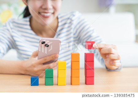 A young woman looking at building blocks A young woman looking at building blocks 139385475