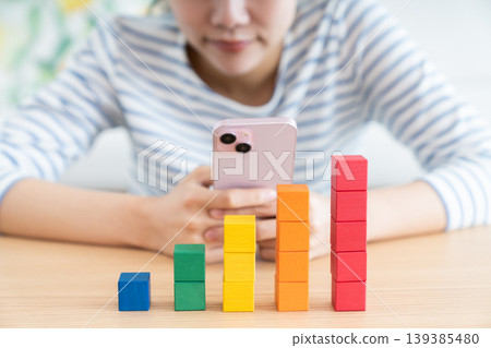 A young woman looking at building blocks A young woman looking at building blocks 139385480