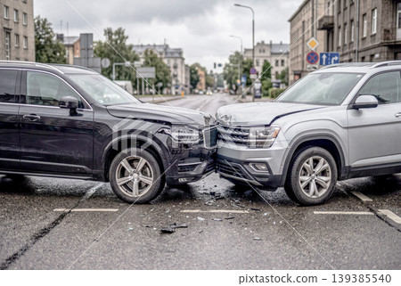 The scene of a head-on collision between two cars on a wet road. The scene of a head-on collision between two cars on a wet road. 139385540