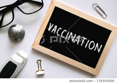 Vaccination text on chalkboard on white background, healthcare medical concept Vaccination text on chalkboard on white background, healthcare medical concept 139385600