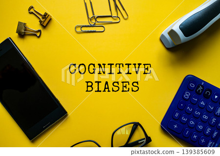 Cognitive Biases text on yellow background with glasses calculator and smartphone, flat lay psychology education concept Cognitive Biases text on yellow background with glasses calculator and smartphone, flat lay psychology education concept 139385609