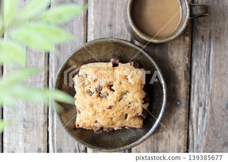 Enjoying chocolate chunk scones and café au lait in Yachimun pottery during coffee time. Enjoying chocolate chunk scones and café au lait in Yachimun pottery during coffee time. 139385677