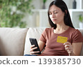 Sad asian woman paying online at home 139385730