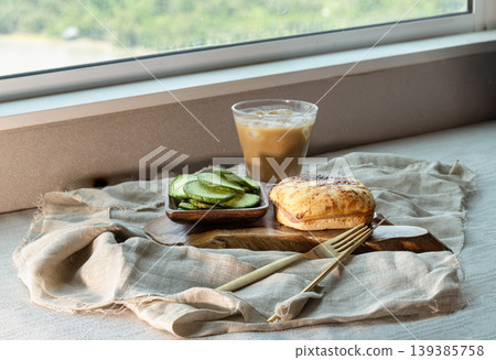 Bathed in the glow of a sun-drenched window, this artisanal breakfast is a study in texture and light. At its heart lies a golden-brown pastry, its cheese-dusted crust blistered to a perfect, savory Bathed in the glow of a sun-drenched window, this artisanal breakfast is a study in texture and light. At its heart lies a golden-brown pastry, its cheese-dusted crust blistered to a perfect, savory 139385758