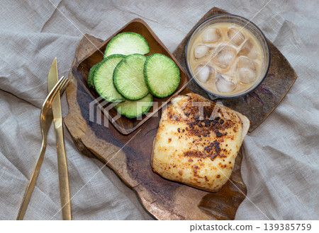 At its heart lies an artisanal ham and cheese toastie, crowned with a molten, bubbling layer of fromage. Expertly charred, its surface offers a sophisticated contrast between creamy gold and deep, 139385759