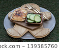 A masterclass in culinary balance, this dish transforms breakfast into an art form. The centerpiece an artisanal ham and cheese toastie boasts a perfectly charred, molten crust, paired with the 139385760