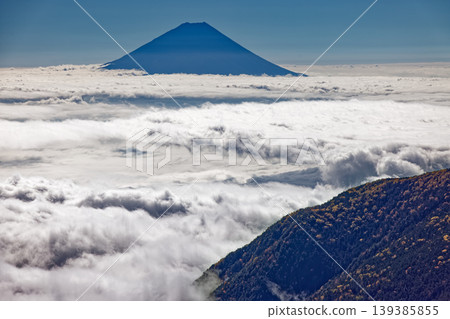 Mount Fuji above the clouds as seen from the Southern Alps, Houou Sanzan, and Sunaharai-dake. Mount Fuji above the clouds as seen from the Southern Alps, Houou Sanzan, and Sunaharai-dake. 139385855