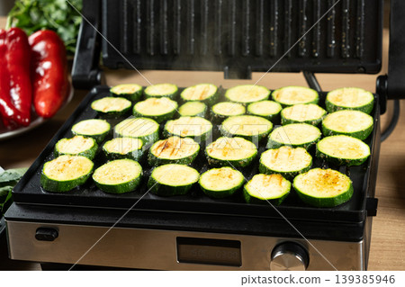 Organic Zucchini Rounds Grilling with Visible Steam and Grill Marks Organic Zucchini Rounds Grilling with Visible Steam and Grill Marks 139385946