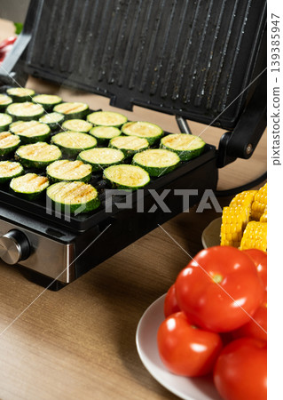 Organic Zucchini Rounds Grilling with Visible Steam and Grill Marks Organic Zucchini Rounds Grilling with Visible Steam and Grill Marks 139385947