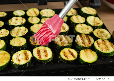 Basting Grilled Zucchini Slices with Oil Using Silicone Brush Basting Grilled Zucchini Slices with Oil Using Silicone Brush 139385950
