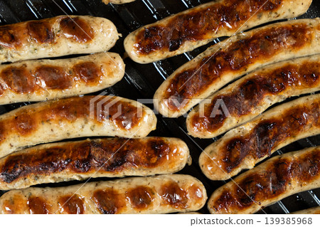 Batch of Sausages Roasting on Modern Electric Home Grill Batch of Sausages Roasting on Modern Electric Home Grill 139385968