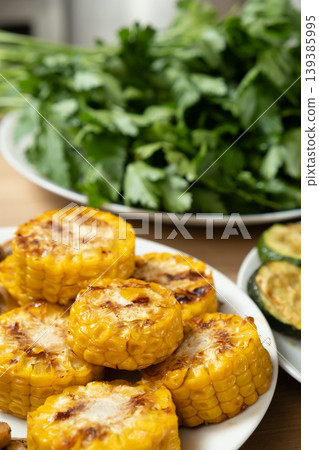 Golden charred corn cobs for healthy BBQ snack Golden charred corn cobs for healthy BBQ snack 139385995