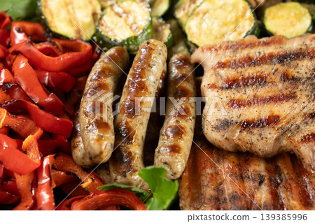 Assorted grilled meat, sausages and vegetables background Assorted grilled meat, sausages and vegetables background 139385996