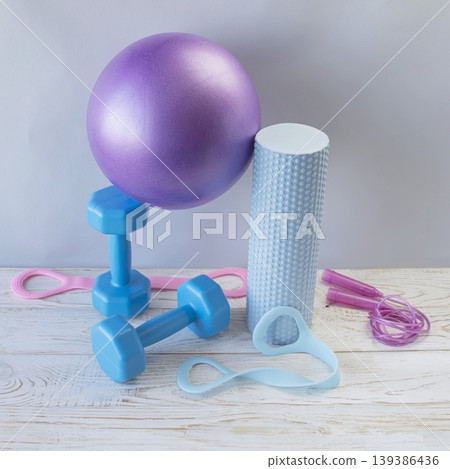 Fitness equipment for home yoga and pilates workouts with dumbbells, yoga ball, massage roller, resistance bands and skipping rope Fitness equipment for home yoga and pilates workouts with dumbbells, yoga ball, massage roller, resistance bands and skipping rope 139386436