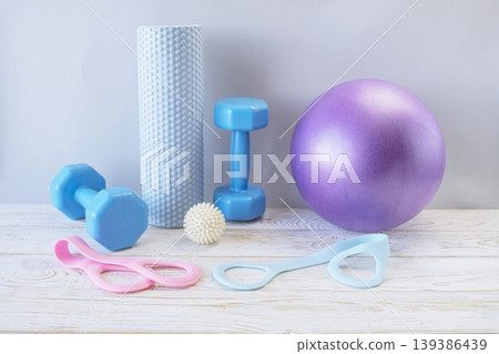 Fitness equipment for home yoga and pilates workouts with dumbbells, yoga ball, massage roller, resistance bands and skipping rope Fitness equipment for home yoga and pilates workouts with dumbbells, yoga ball, massage roller, resistance bands and skipping rope 139386439