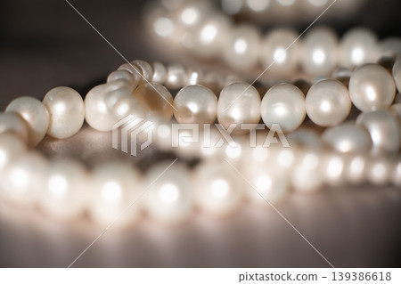 Pearl strands on gray background, luxury jewelry texture with elegant composition. Pearl strands on gray background, luxury jewelry texture with elegant composition. 139386618