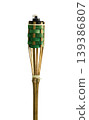 Bamboo torch with green bamboo weaving providing garden lighting 139386807