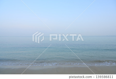 Calm clear sea meeting sandy beach horizon Calm clear sea meeting sandy beach horizon 139386811